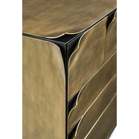 Corner detail of brass dresser, sleek design.