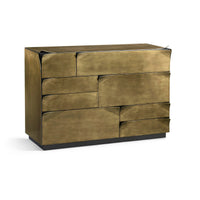 Angled view of brass dresser, closed drawers.