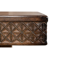 Edge design close-up of carved console table.