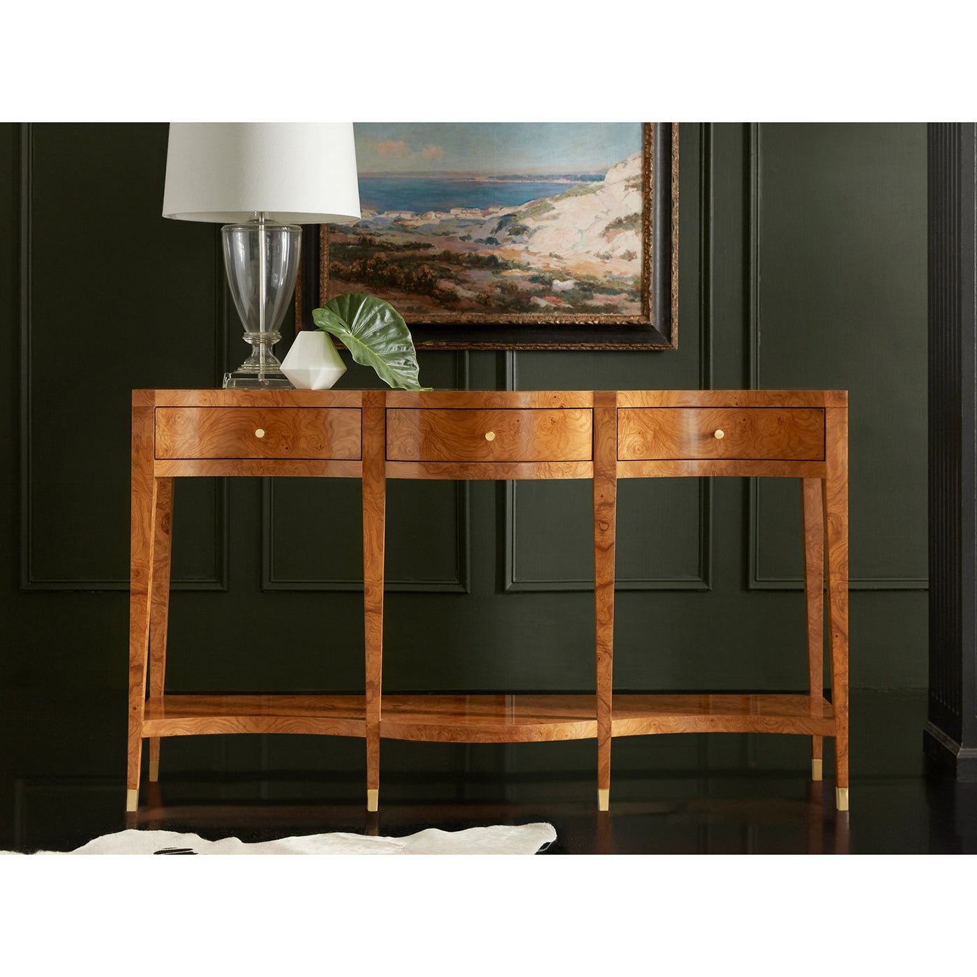 Ash burl console table styled in room, lamp on top.