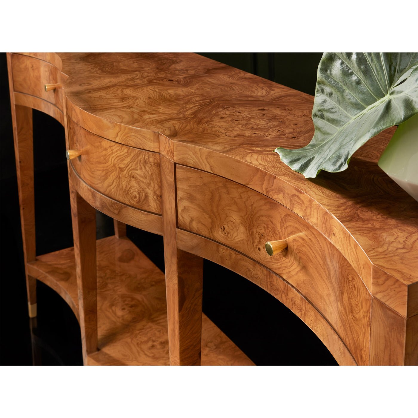 Close-up of textured ash burl console table surface.