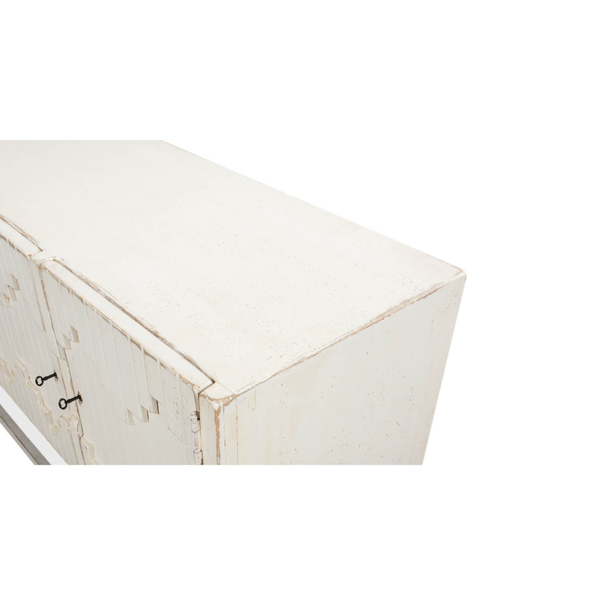Close-up corner of Aztec sideboard, textured white surface.