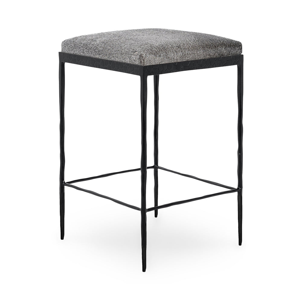 Three-quarter view of gray backless hair-on-hide counter stool with a square seat and black iron frame.