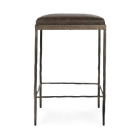Straight-on view of dark brown backless leather counter stool with slim hammered iron legs.