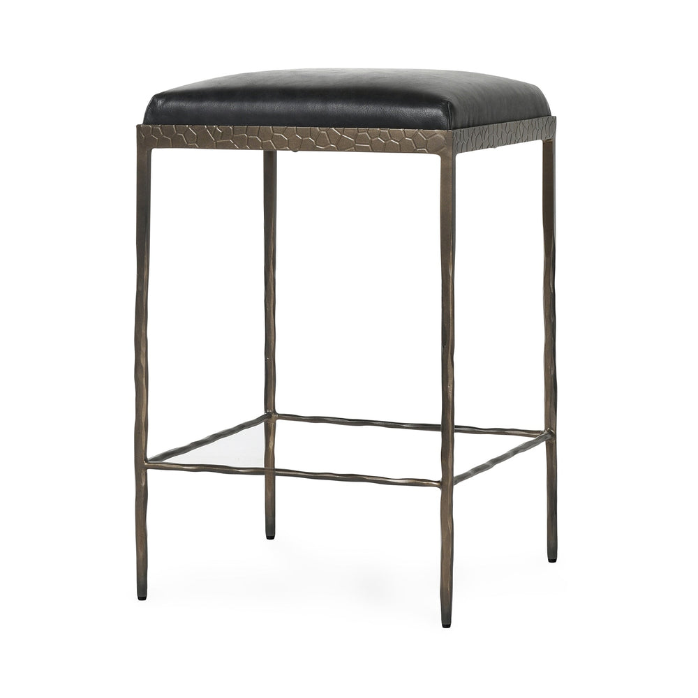 Three-quarter view of black backless leather counter stool with a square padded seat and iron footrails.