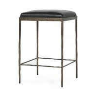 Three-quarter view of black backless leather counter stool with a square padded seat and iron footrails.