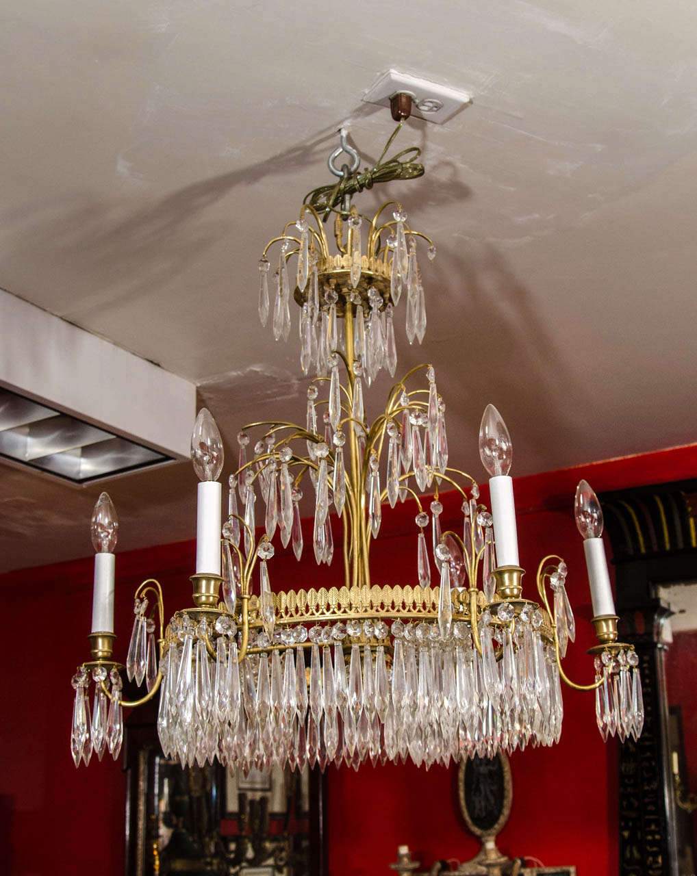 Baltic Six Light Chandelier installed in red room.