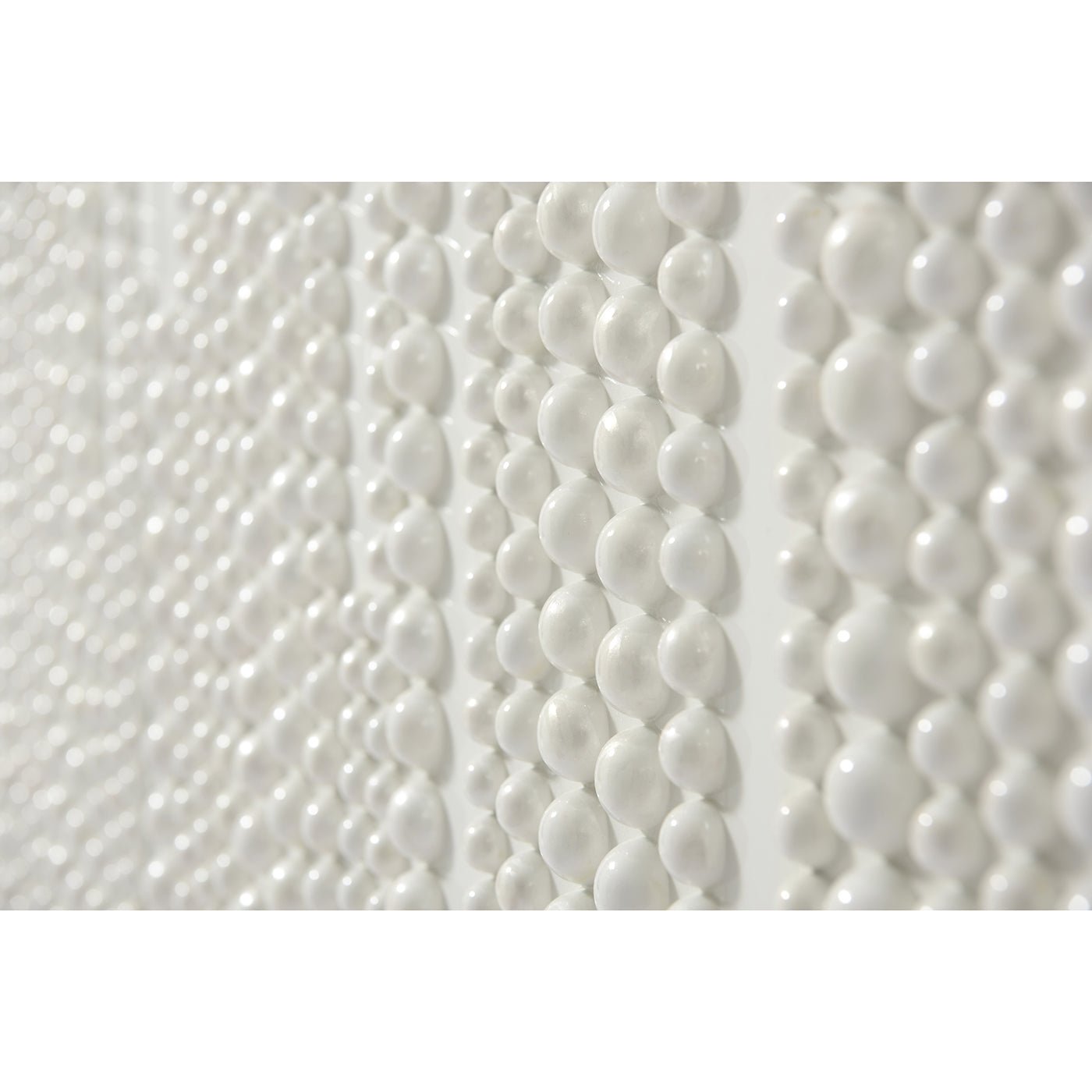 Close-up of bead texture on white cabinet surface.