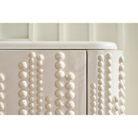 Detail view of beaded texture on cabinet corner.
