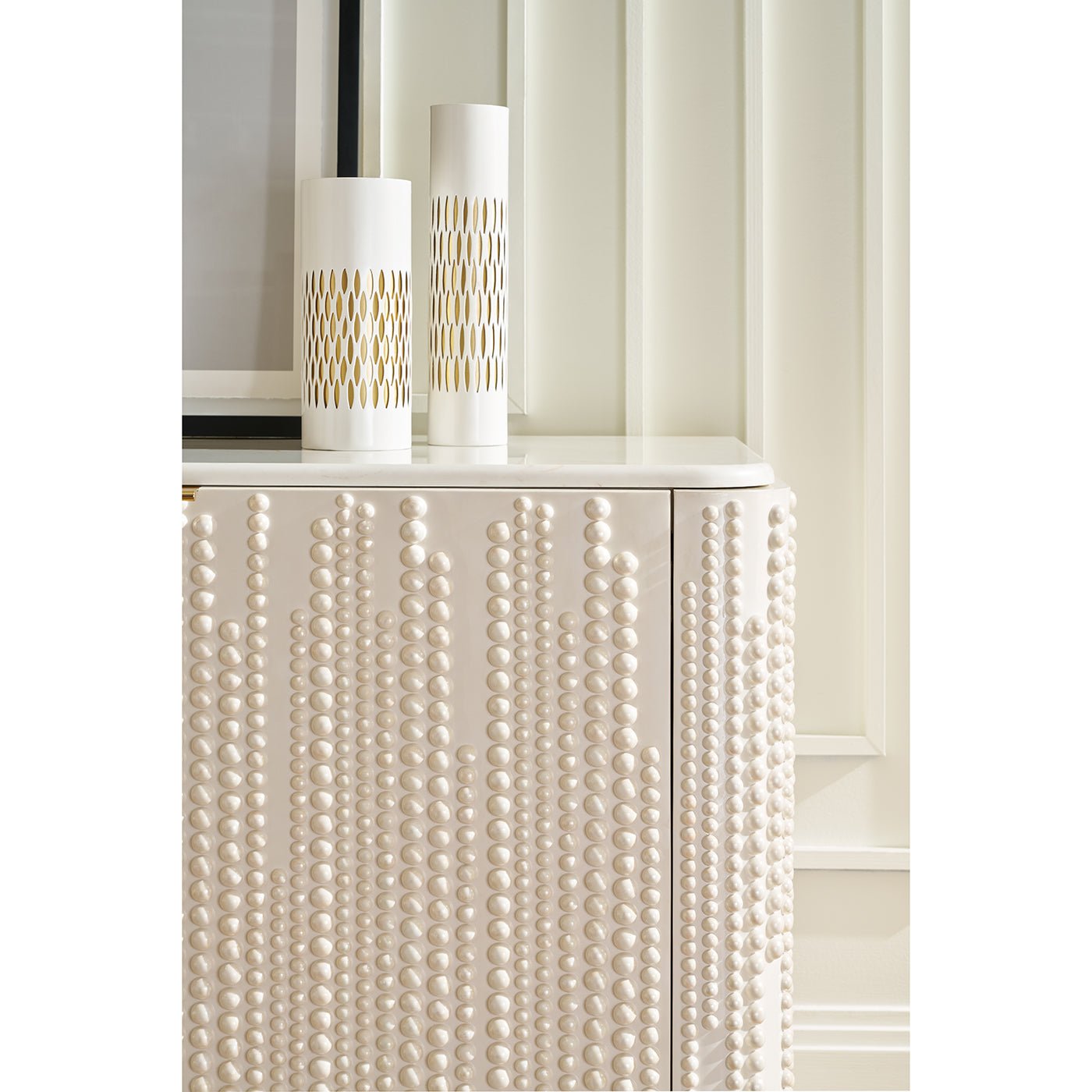 White beaded cabinet with vases, decorative setting.