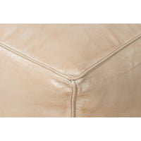 Beige leather cube stool, close-up corner detail.