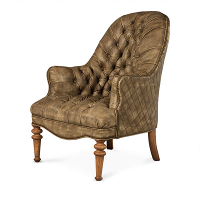 Beige tufted leather chair with wooden legs.