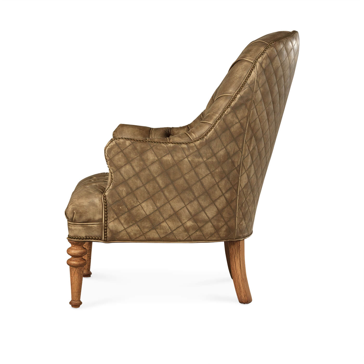 Side view of beige tufted leather chair.