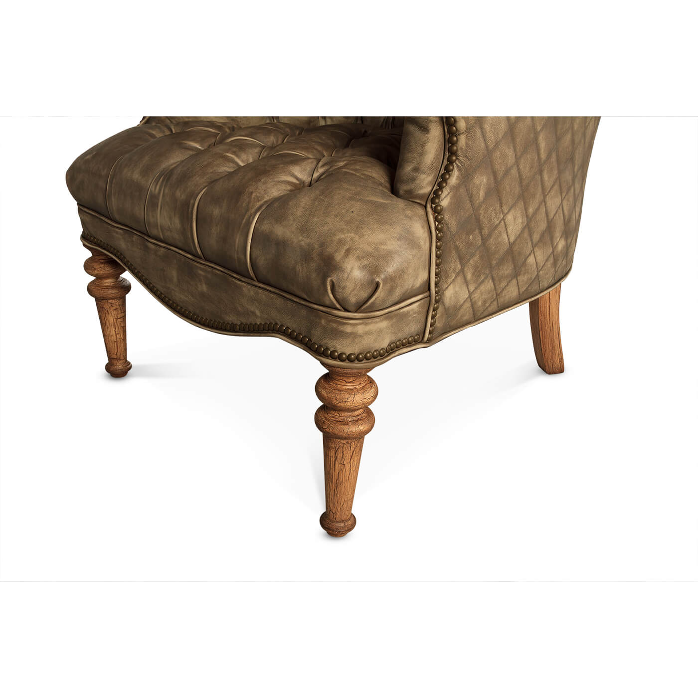 Wooden legs and base of tufted leather chair.