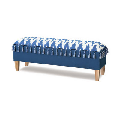 Coastal blue upholstered bench with tassel details, angled view.
