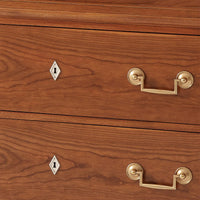 Detailed view of Biedermeier dresser keyhole and handles.