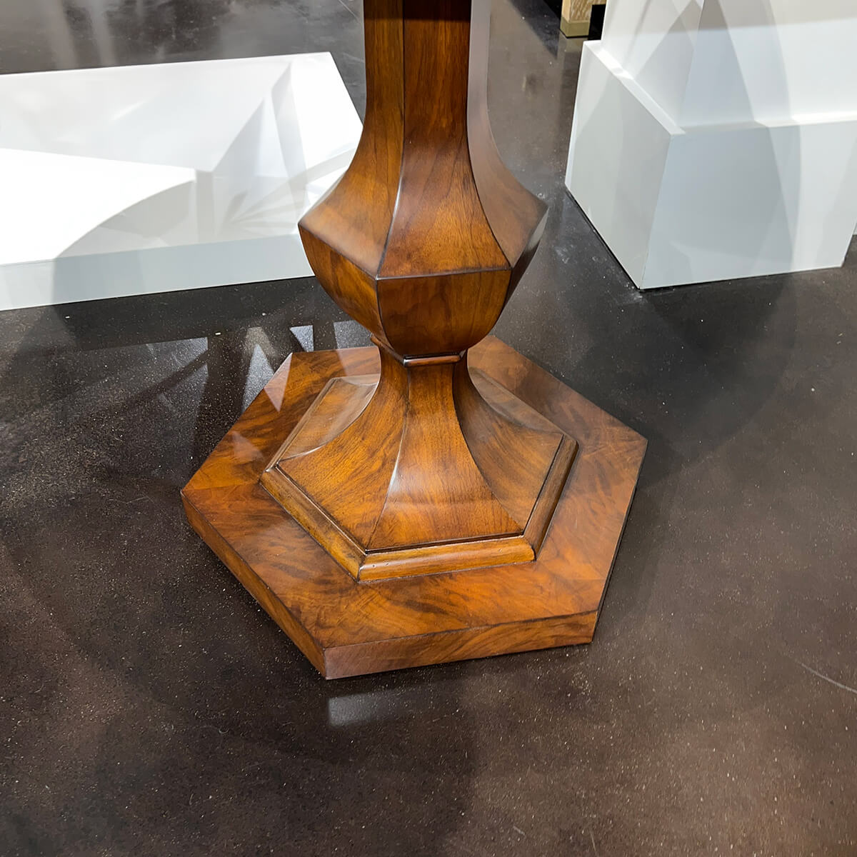 Hexagonal pedestal base detail of walnut table.
