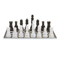 Chess board front view, black and white pieces aligned.