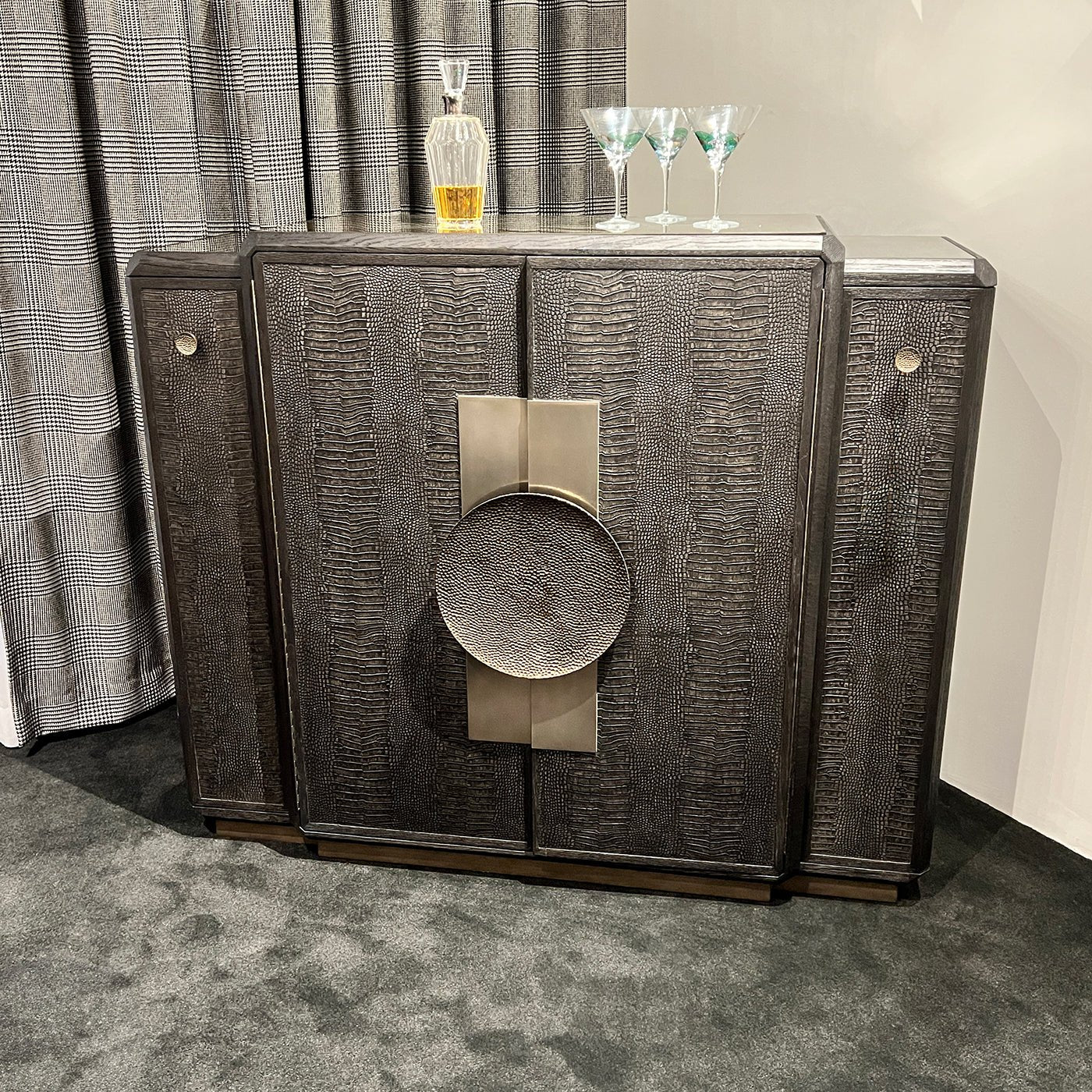 Black Art Deco Bar Cabinet with drinks and glassware on top.