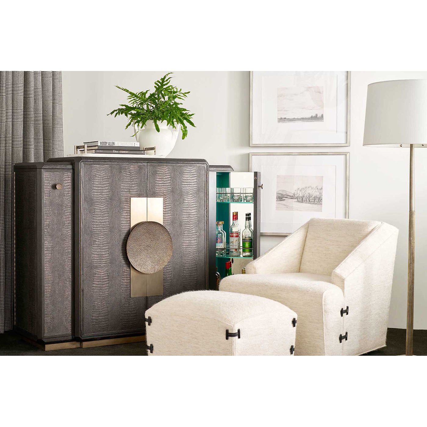 Black Art Deco Bar Cabinet next to chair and lamp.