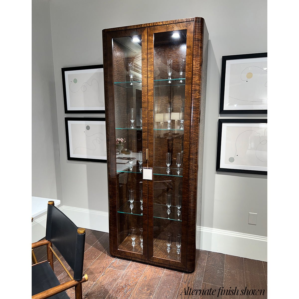 Glass shelves inside curio cabinet with alternate finish