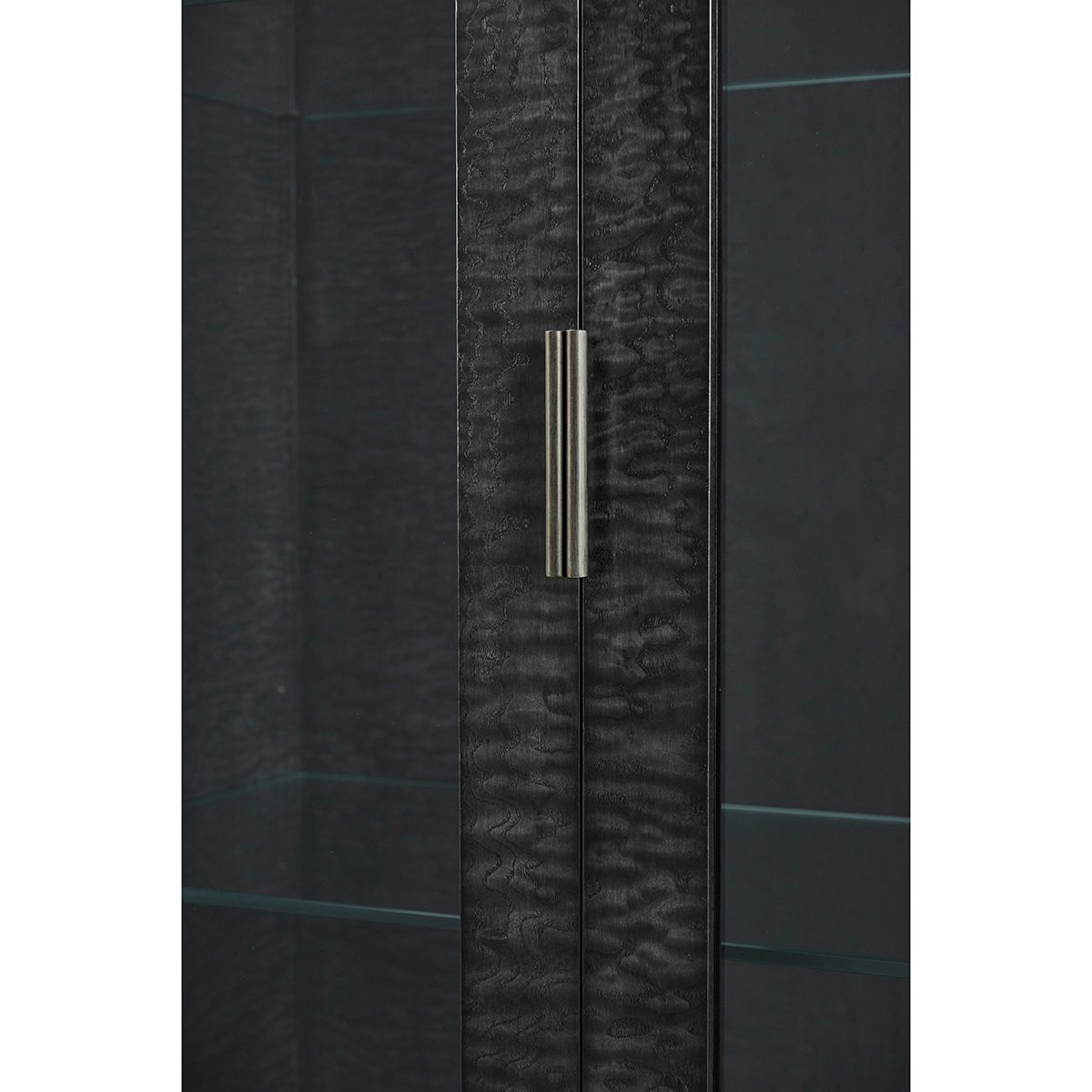 Close-up door handle on Black Burl cabinet