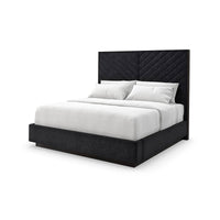 Black king bed with chevron-tufted headboard, white bedding.