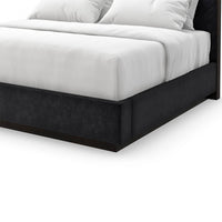 Detailed view of black upholstered bed frame and mattress.