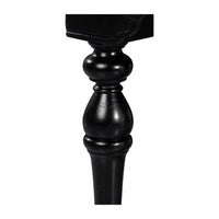 Turned leg detail of black console table, close-up.