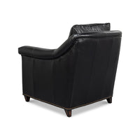 Rear angled view of black leather accent chair.