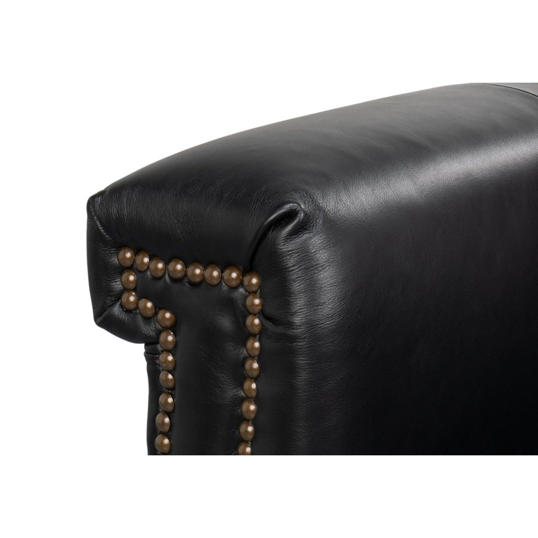 Close-up of armrest studs on leather accent chair.