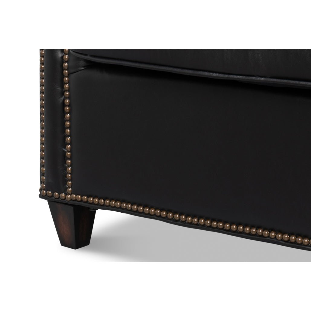 Close-up of chair leg and studded base detail.