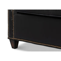 Close-up of chair leg and studded base detail.