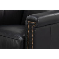 Armrest detail of black leather accent chair with studs.