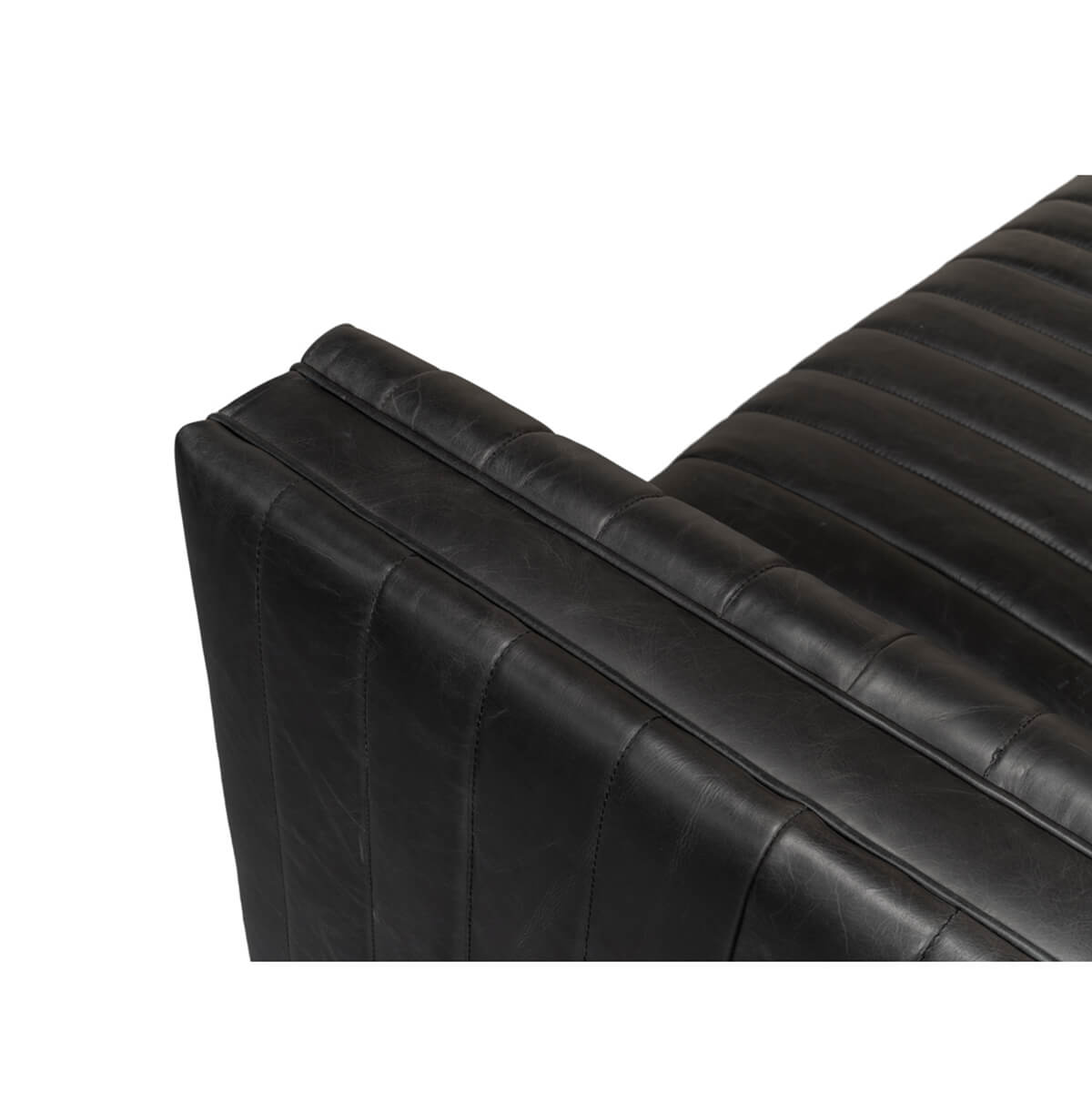 Black leather sofa stitching detail, corner view.