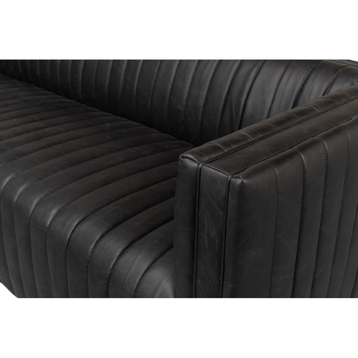 Black leather sofa detailed close-up, armrest and seat.
