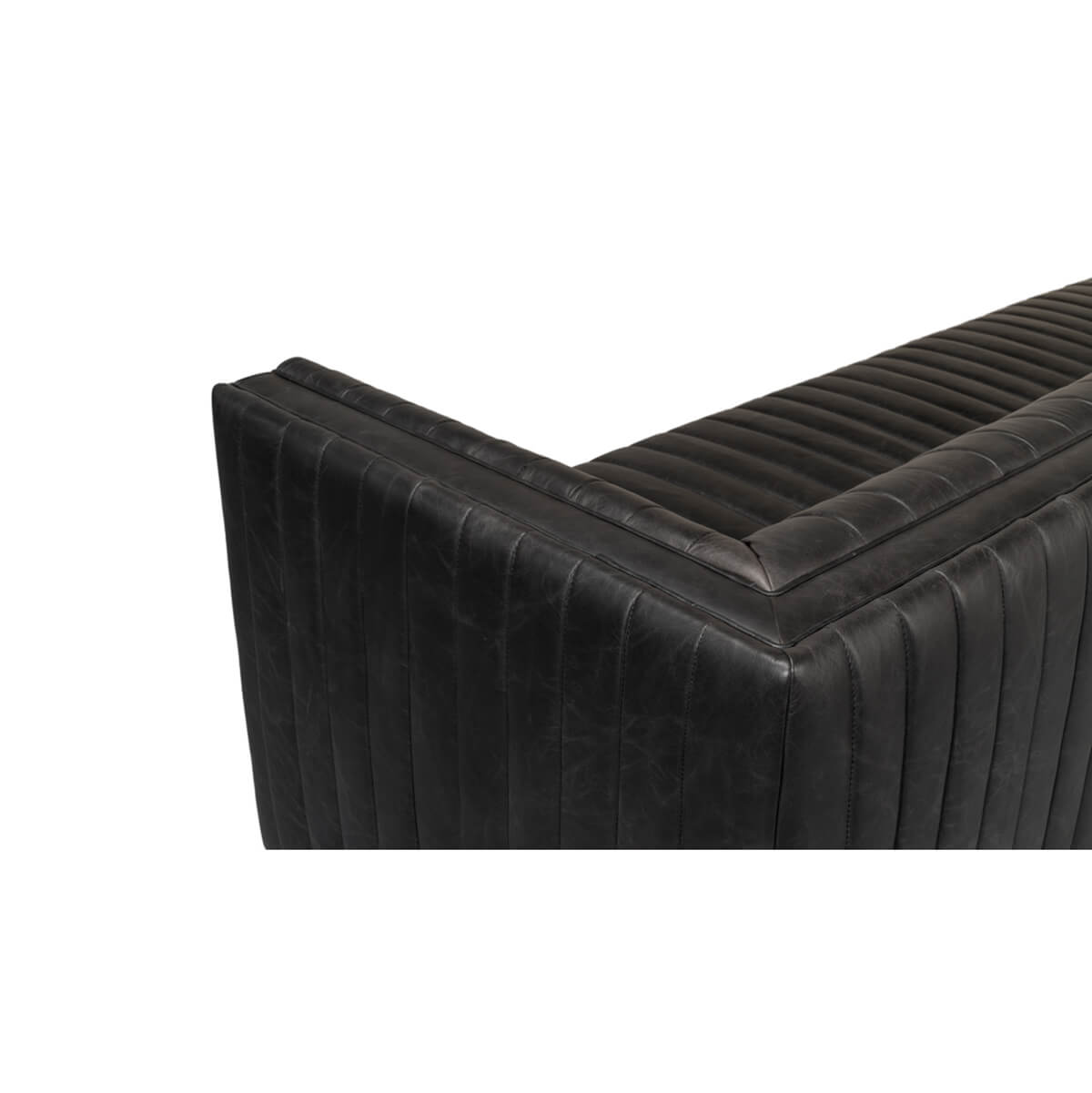 Black leather sofa top corner angle, detailed stitching.