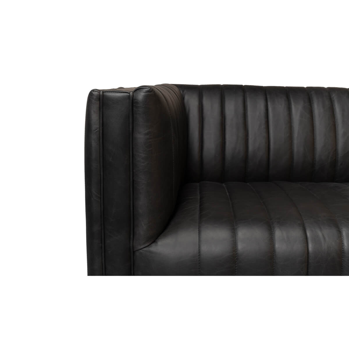 Black leather sofa close-up, armrest and seat detail.