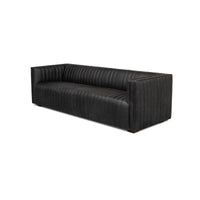 Black leather sofa side angle view, detailed stitching.