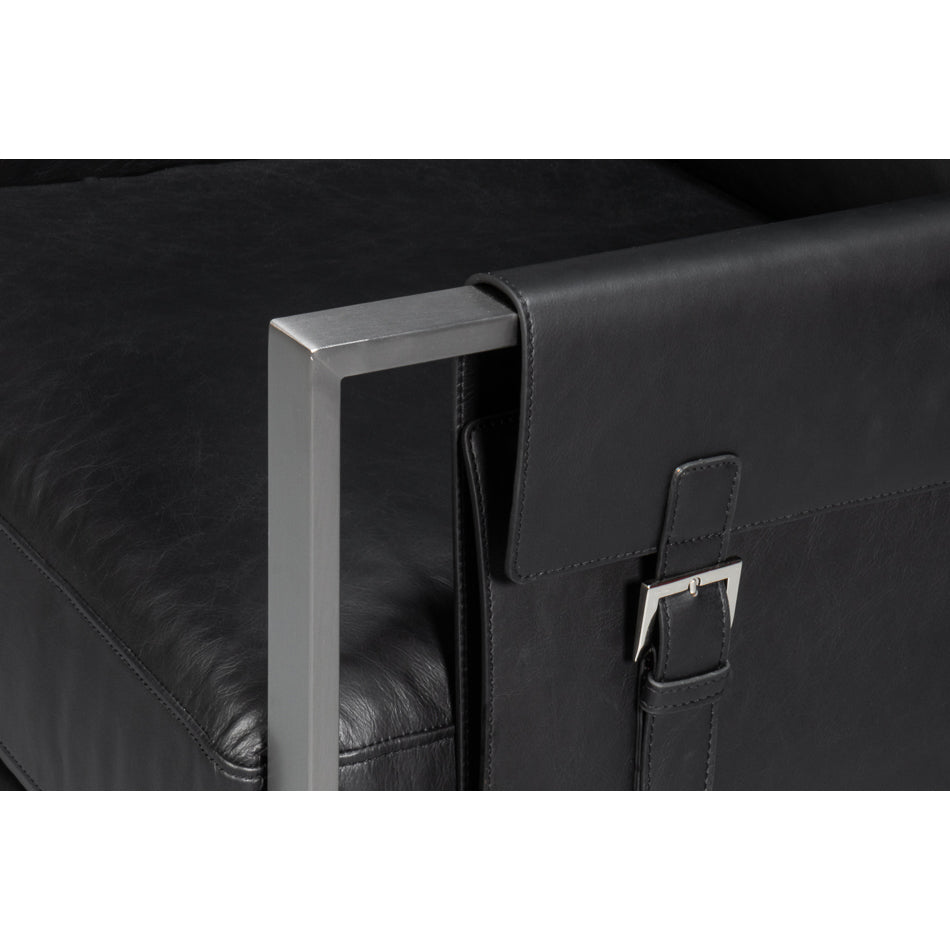 Close-up buckle detail, black leather accent chair.
