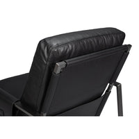 Backrest close-up, black leather accent chair.