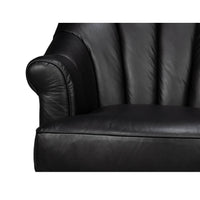 Close-up of swivel chair arm, black leather detail.
