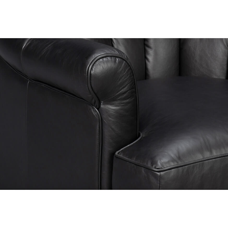 Armrest and seat detail of black leather swivel chair.