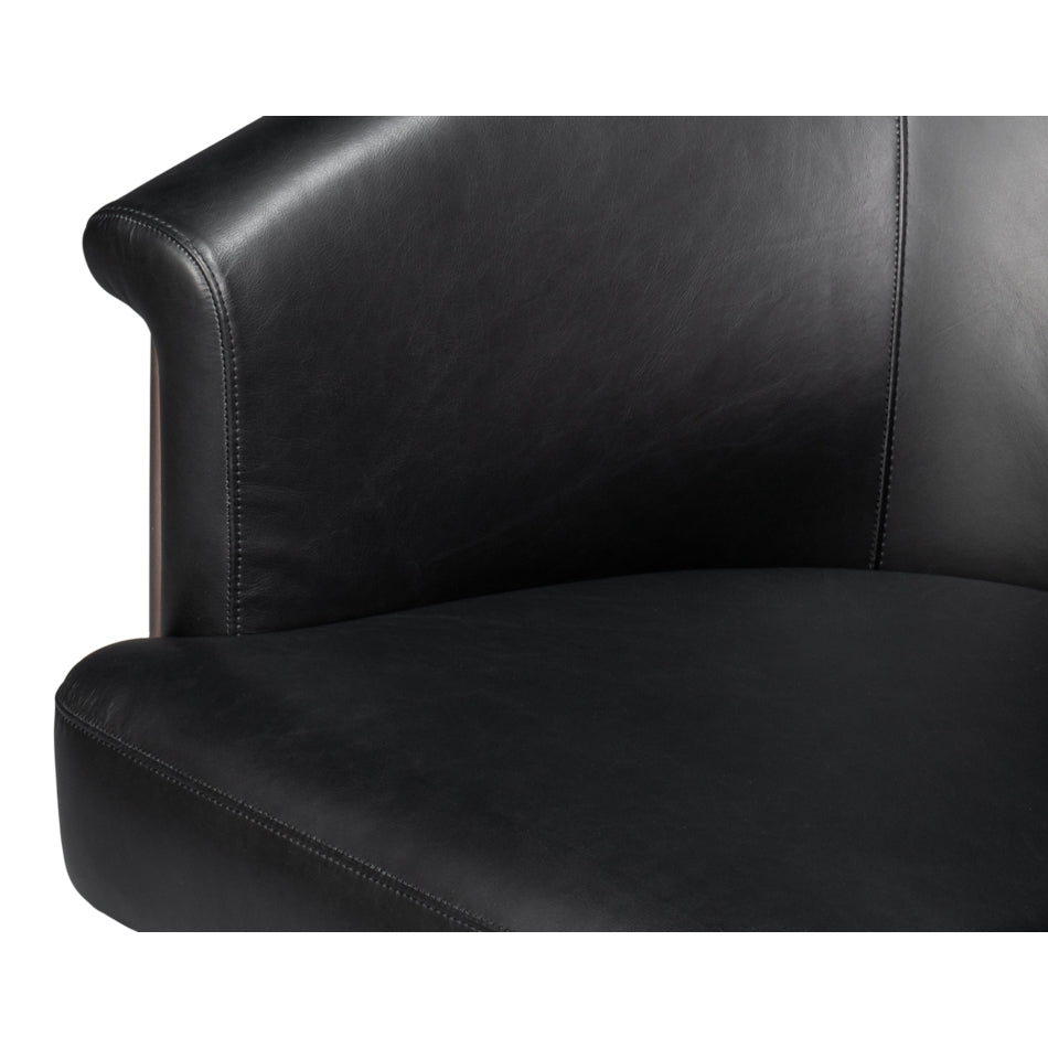 Close-up of black leather tub chair seat corner.