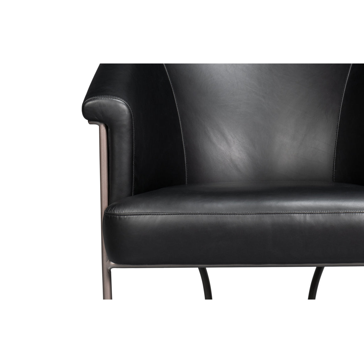 Close-up of black leather tub chair seat.