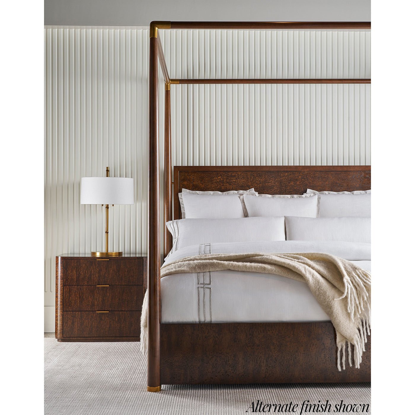 Brown alternate finish canopy bed beside nightstand.