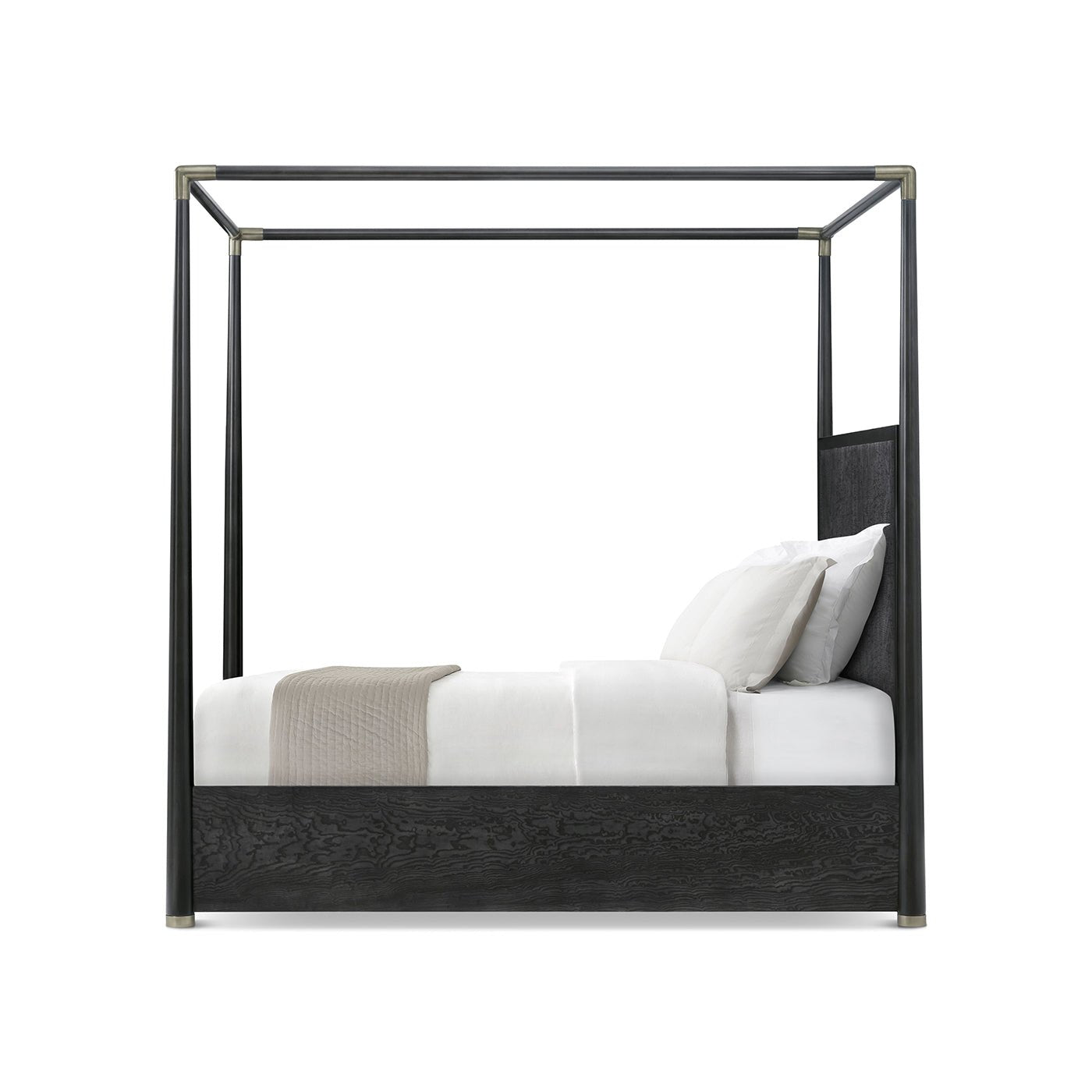 Side view of black canopy bed with cushions.