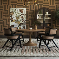 Dining room with armchairs and round table.