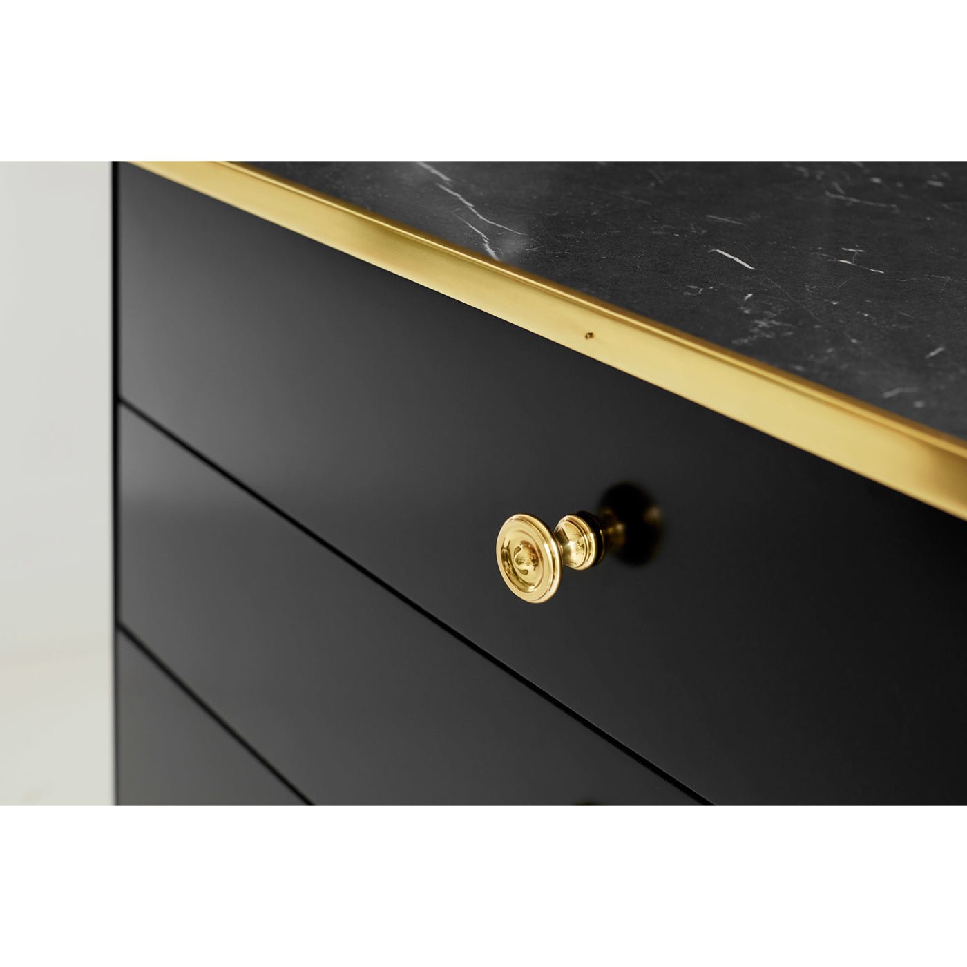 Black mid-century nightstand drawer knob detailed view.