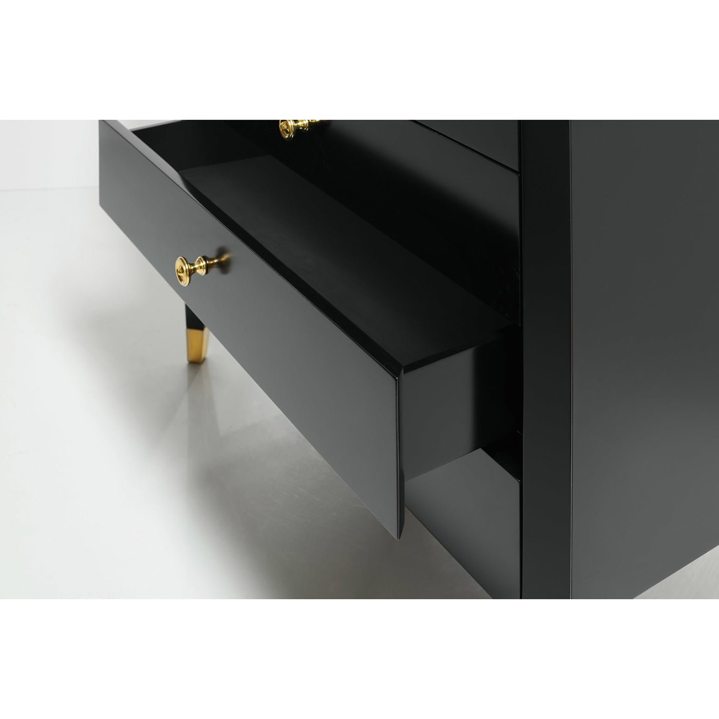 Black mid-century nightstand open drawer showing interior.
